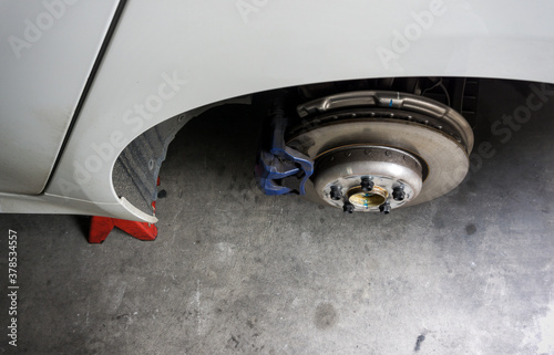 Top view of Rear wheel hub and car disk brake on background  detail of the rear wheel hub with caliper brake in repair car garage.