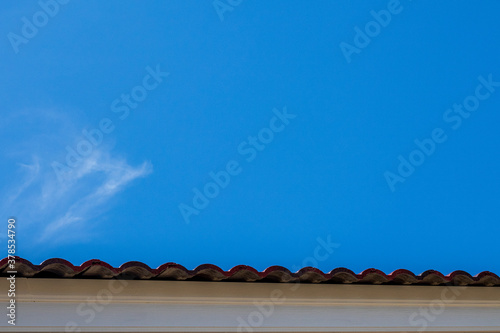 Gray tile roof of construction house with blue sky.