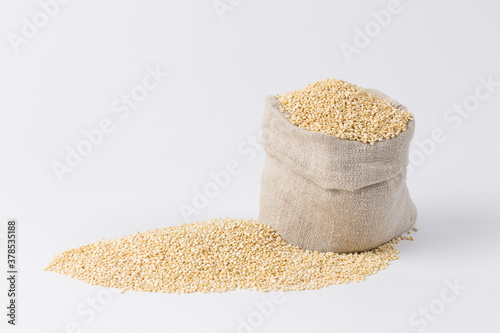 Quinoa groats in sack on black background