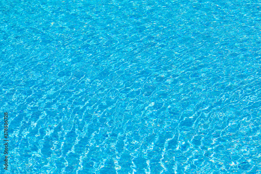 background of reflecting water inof a pool with blue tiles