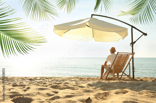 Man enjoying his summer vacation on sandy beach