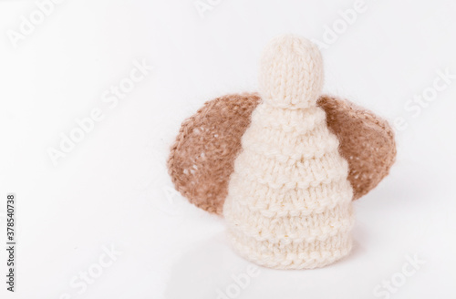 White crocheted Christmas angel on a white background