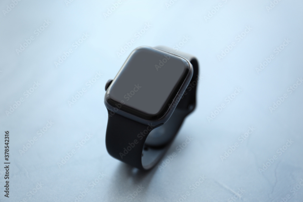 Stylish smart watch on grey stone table, closeup Stylish smart watch on grey stone table, closeup