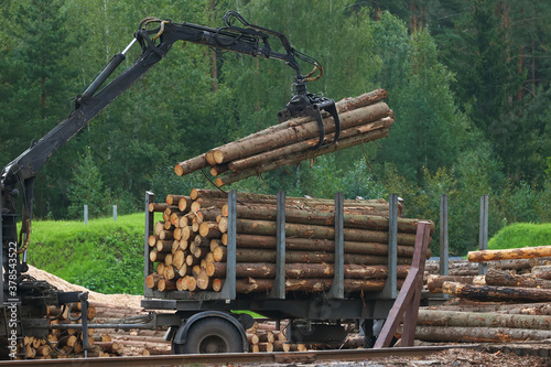 Log truck unloads logs at the sawmill