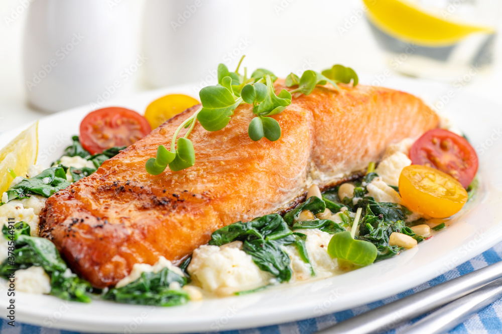 Grilled salmon steak with vegetables and fresh microgreens. Food concept for a ketogenic and no carbohydrate diet. Grilled salmon steak with vegetables and fresh microgreens. Food concept for a ketogenic and no carbohydrate diet.