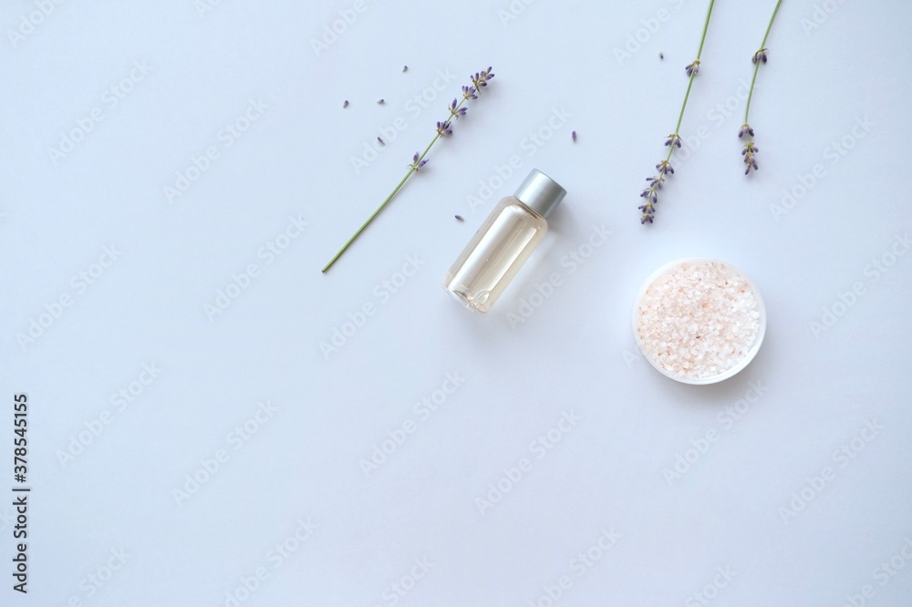 Composition with lavender and beauty products for hair and body care on blue background. Organic SPA beauty products. Flat lay, top view. SPA branding mockups.