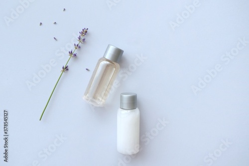 Composition with lavender and beauty products for hair and body care on blue background. Organic SPA beauty products. Flat lay, top view. SPA branding mockups.