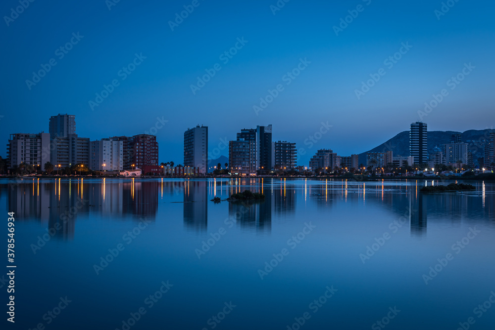 City skyline of Calpe reflected in the salt lake at dusk, Alicante, Spain City skyline of Calpe reflected in the salt lake at dusk, Alicante, Spain