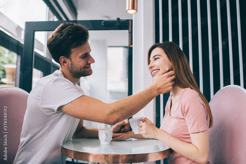 Man in love touching girlfriend face in cafe Man in love touching girlfriend face in cafe