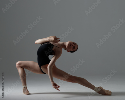 Young beautiful ballet dancer is posing in studio photo