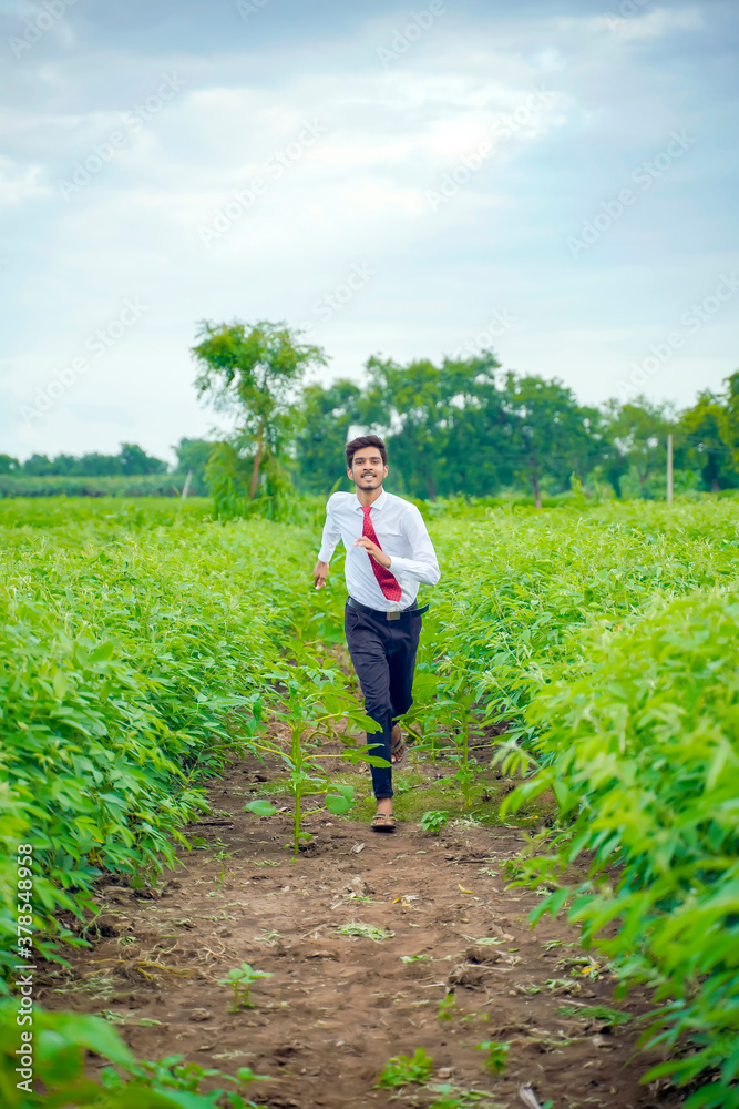 Young asian / Indian man running at agriculture field