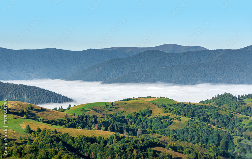 View of the mountain landscape and the mist-shrouded valley. Carpathians.