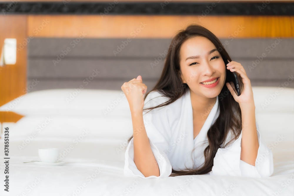 Portrait beautiful young asian woman use smart mobile phone on bed Portrait beautiful young asian woman use smart mobile phone on bed