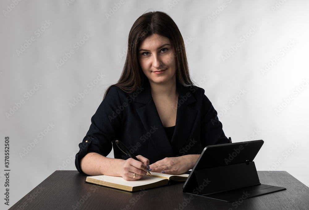 Young woman in blue with tablet and notebook. Young woman in blue with tablet and notebook.