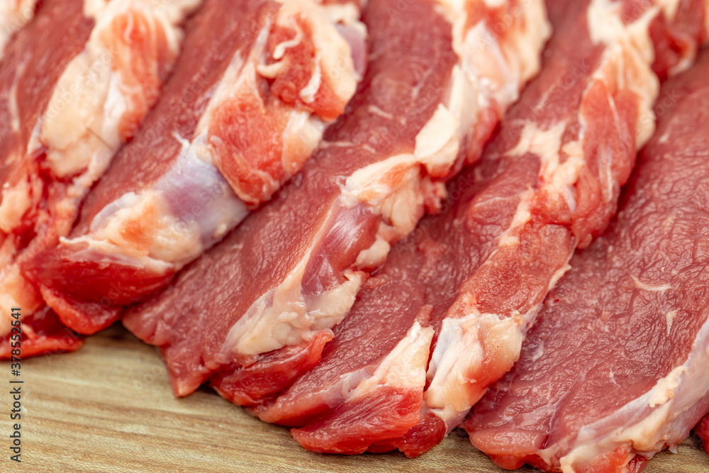 Fresh raw beef steak on a wooden background close-up. Fresh raw beef steak on a wooden background close-up.