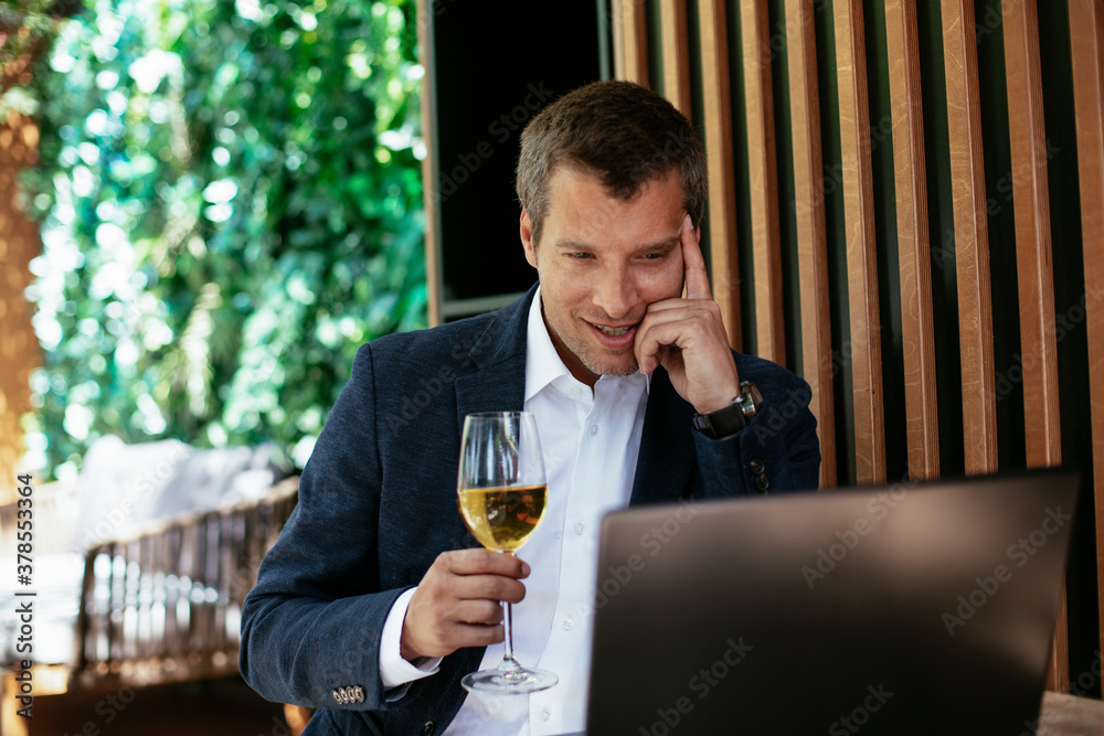 Handsome businessman dressed in the suit drinking wine. Businessman enjoying in the restaurant. Handsome businessman dressed in the suit drinking wine. Businessman enjoying in the restaurant.