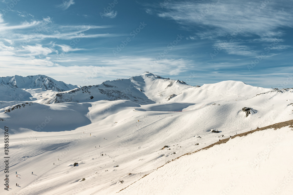 Scenic panoramic view of Silvretta ski area at Iscgl and Samnaun skiing resort with chairlifts , downhill slpoes and clear blue sky on background. Winter sport travel recreation and activities