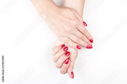 Woman s hands with nail red manicure isolated on white background  close up view. Classic red manicure  concept of beauty salon