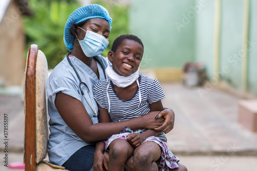 Closeup shot of a boy and a doctor wearing sanitary masks