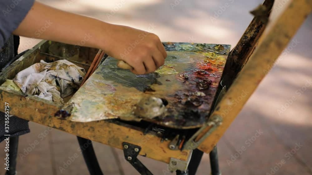 woman hand painting picture of city landscape with brush and oil paints. People and creativity concept woman hand painting picture of city landscape with brush and oil paints. People and creativity concept
