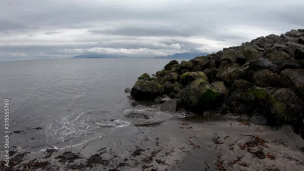 Sea waves break on rocks on Iceland seashore. Sea waves break on rocks on Iceland seashore.