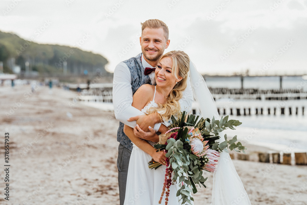 couple in love. Bride and groom happily hugging on the beach. just married