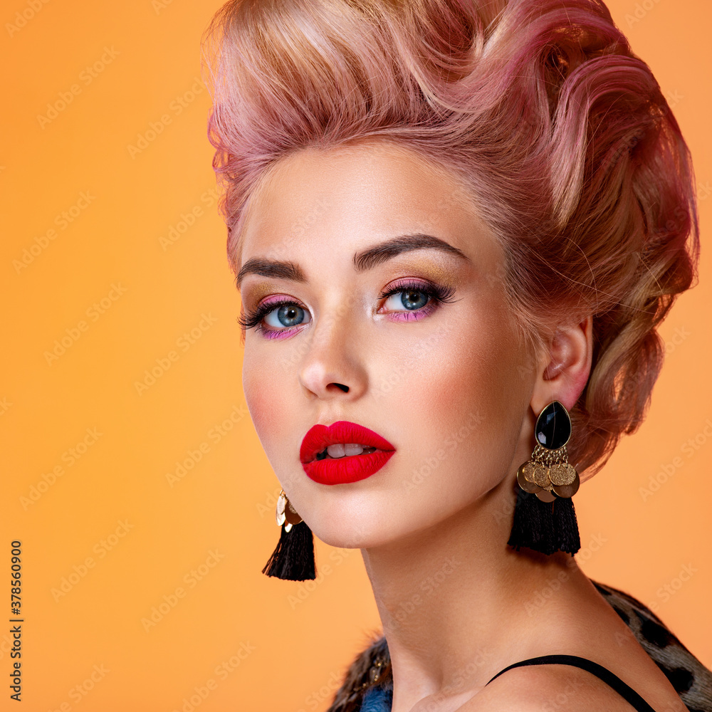 Beautiful woman with creative hairstyle, vivid makeup. Fashionable girl.  Beautiful face of young woman with red lips. Stunning blonde girl. Bright  eye makeup. Attractive caucasian model with earrings Stock Photo | Adobe