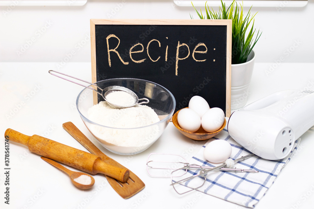 Fototapeta premium making dough for bread or homemade baked goods. ingredients on the table. recipe board