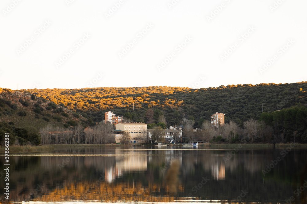 Reflection of calm water at sunset in the lake of the natural park of 'Lagunas de Ruidera' in Ossa de Montiel, Albacete, Spain 