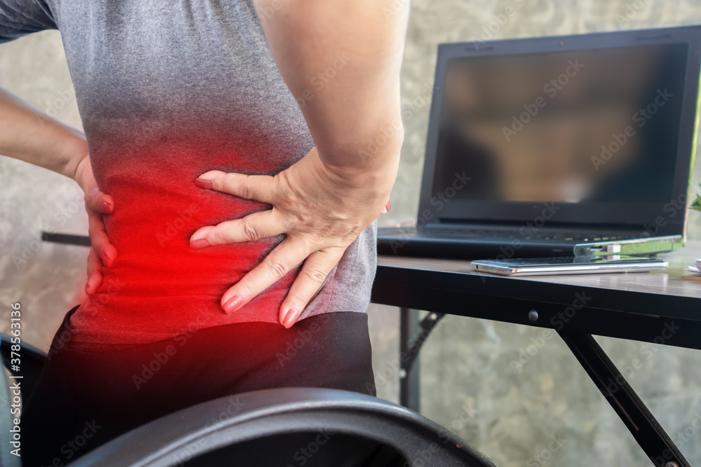 woman suffering from office syndrome having lower back pain sitting on chair 