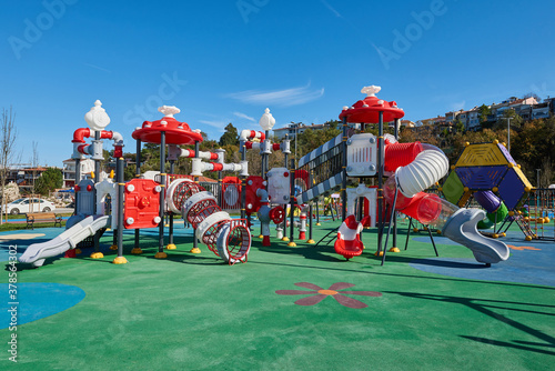 Red and white slides in the child park.