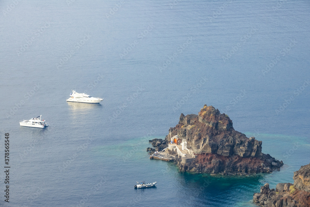 Small Rocky Island and Yachts and Boat Anchored