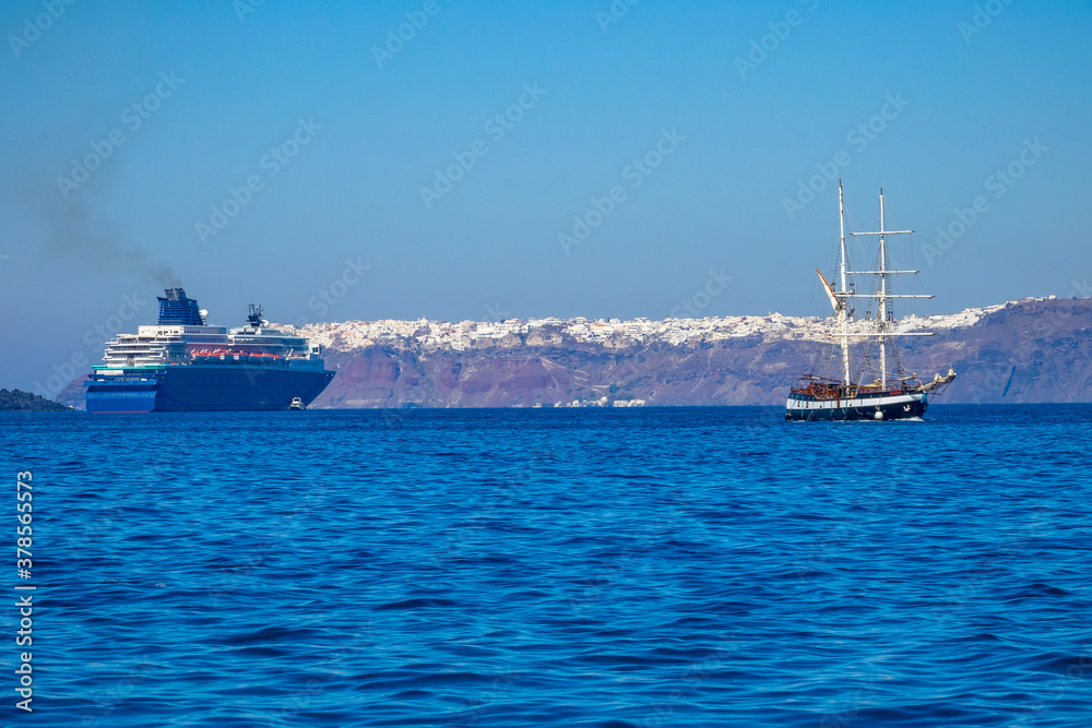 Old Sailing Ship and Modern Cruise Ship off the Coast of Santorini Old Sailing Ship and Modern Cruise Ship off the Coast of Santorini
