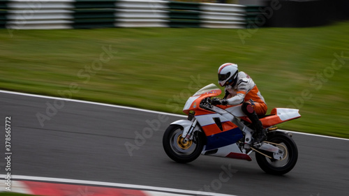 A panning shot of a racing bike as it circuits a track. © SnapstitchPhoto
