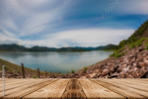 Showcase an old wooden table shelf on a beautiful fall and blurred natural background.