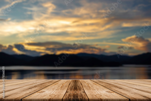 Showcase an old wooden table shelf on a beautiful sunset and blurred nature background.