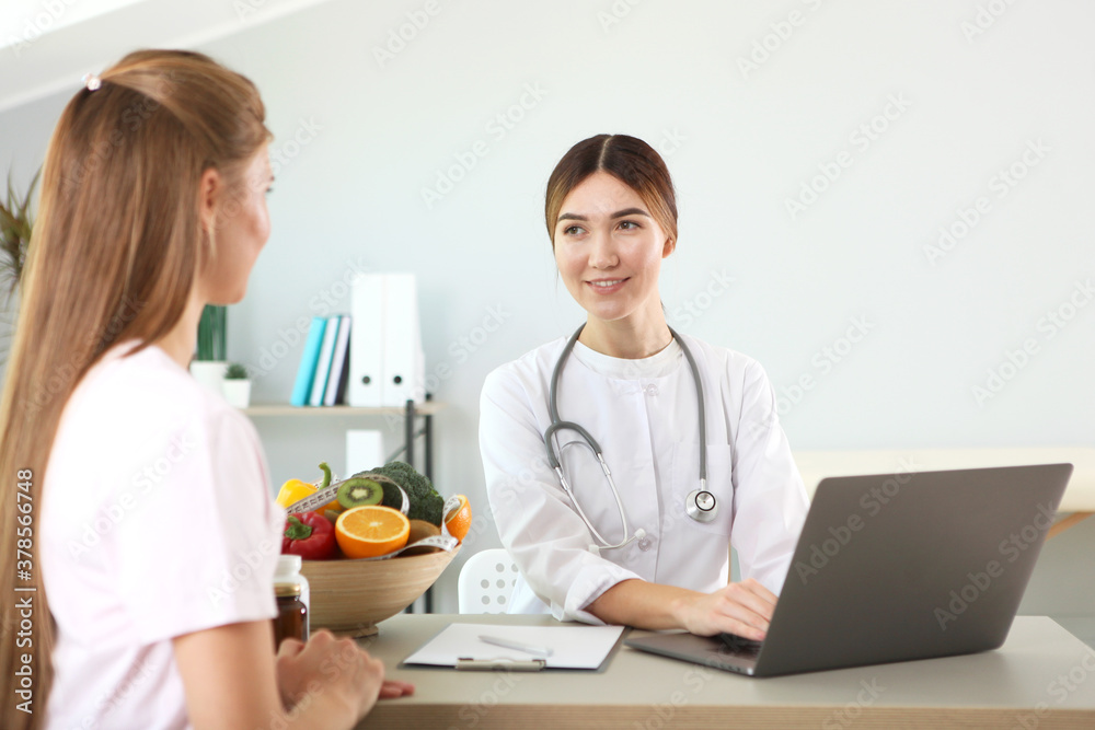 doctor nutritionist takes a patient in the office. proper nutrition, weight control doctor nutritionist takes a patient in the office. proper nutrition, weight control