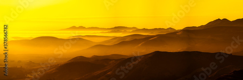 Panorama of Silhouetted mountains at Sunset