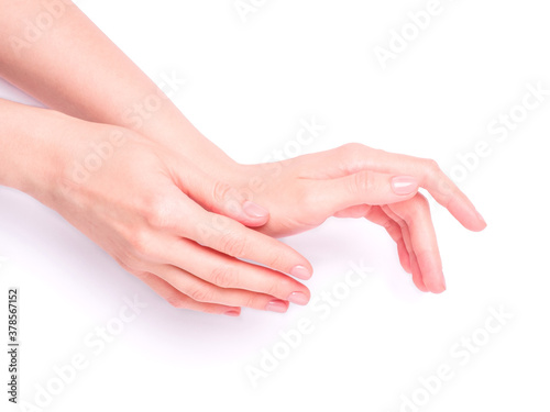 Beautiful female hands showing fresh cute pink manicure, skin and nail care concept, isolated © Frostroomhead