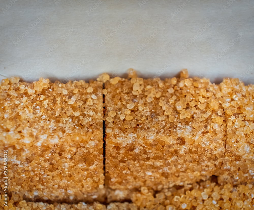 Row of organic brown sugar macro image, copy space