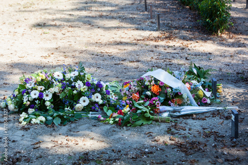 Flowers on a new grave in a cemetery in Rotterdam in the Netherlands