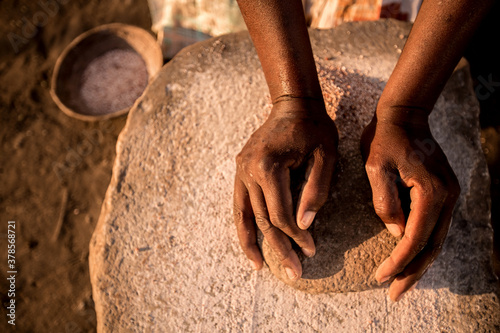 Close-up of a woman preparing grain, Zimbabwe