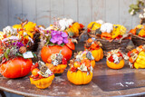 Autumn decor, compositions with pumpkins and seasonal flowers displayed for sale in a flower shop