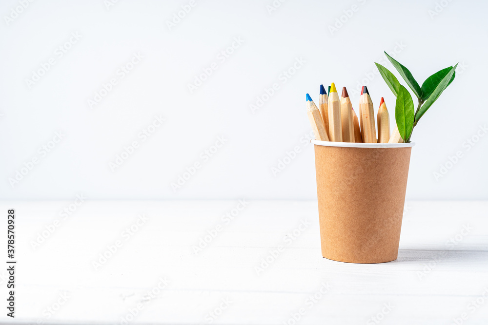 Craft paper coffee cup, pencils, green leaves sprout and recycled stationery. School Zero waste, eco friendly, natural organic plastic free concept. Earth, biodegradable with copy space Craft paper coffee cup, pencils, green leaves sprout and recycled stationery. School Zero waste, eco friendly, natural organic plastic free concept. Earth, biodegradable with copy space