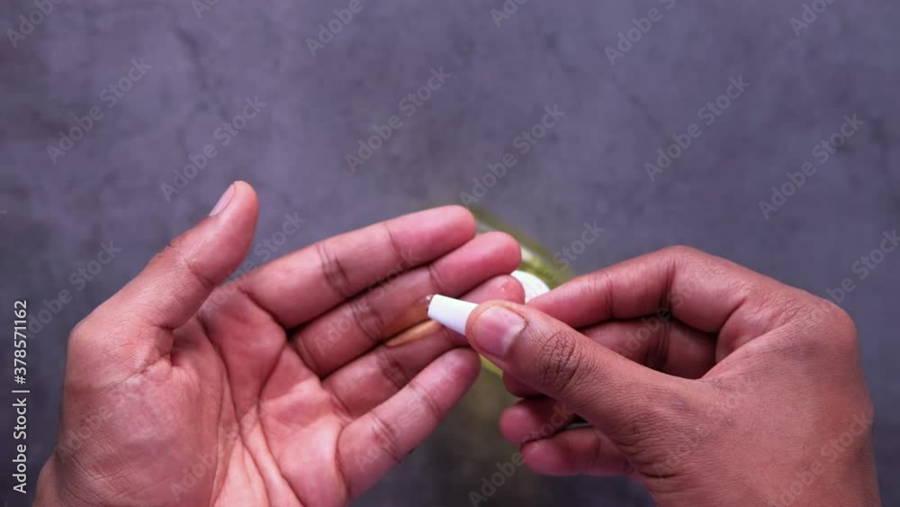 Top view of young man hand using sanitizer gel on black background Top view of young man hand using sanitizer gel on black background