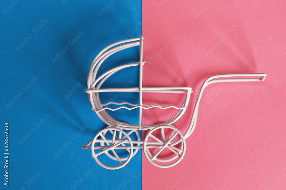 vintage baby stroller on pink and blue background. Boy or girl question