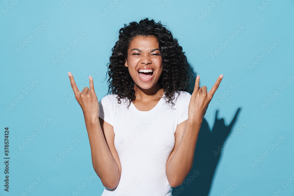 Image of joyful african american girl showing horns gesture Image of joyful african american girl showing horns gesture