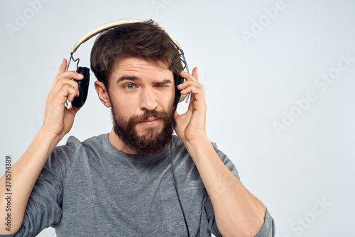 Man in headphones listens to music lifestyle modern style technology light background