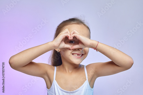 the little girl folded her hands in the shape of a heart
