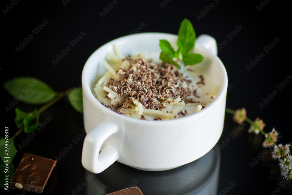 sweet noodles with milk and grated chocolate in a bowl sweet noodles with milk and grated chocolate in a bowl